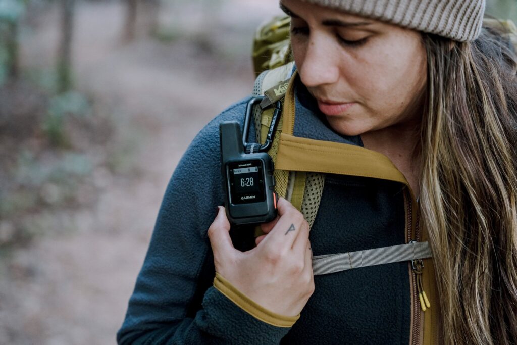On of my hiking safety tips - bring a reliable means of communication! In this image, Bethany (the author of this post) shows her Garmin inReach attached to her hiking pack. 